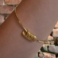 1703111500 - PULSEIRA FIO LISO COM 8 AROS PENDURADOS TAM 65MM<br>QTDE PCT: 3 PC - VAL PCT: R$ 16,35 - PESO UNIT: 6,900g